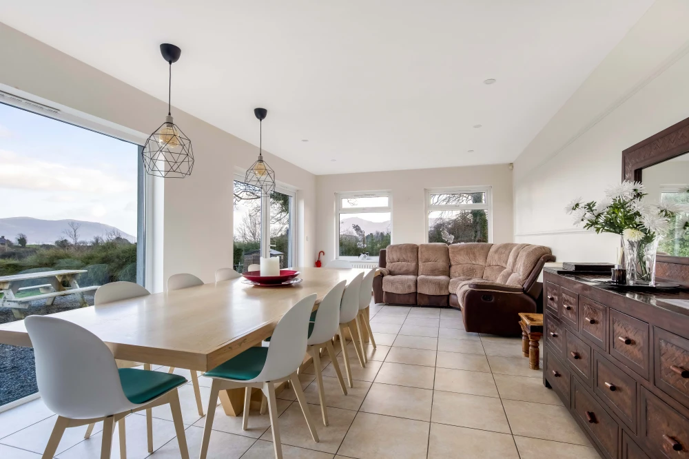 Modern open-plan living and dining area in Berta's Cottage with mountain views