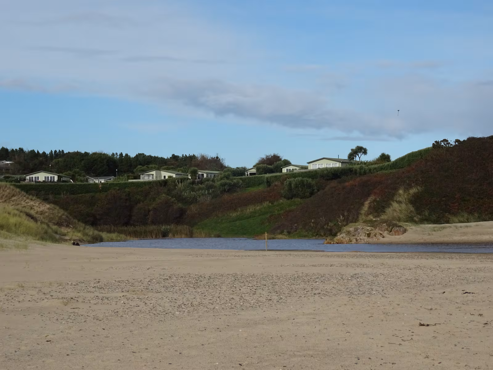 The stream running through the dune system at Brittas Bay County Wicklow with marram grass and coastal dune vegetation visible