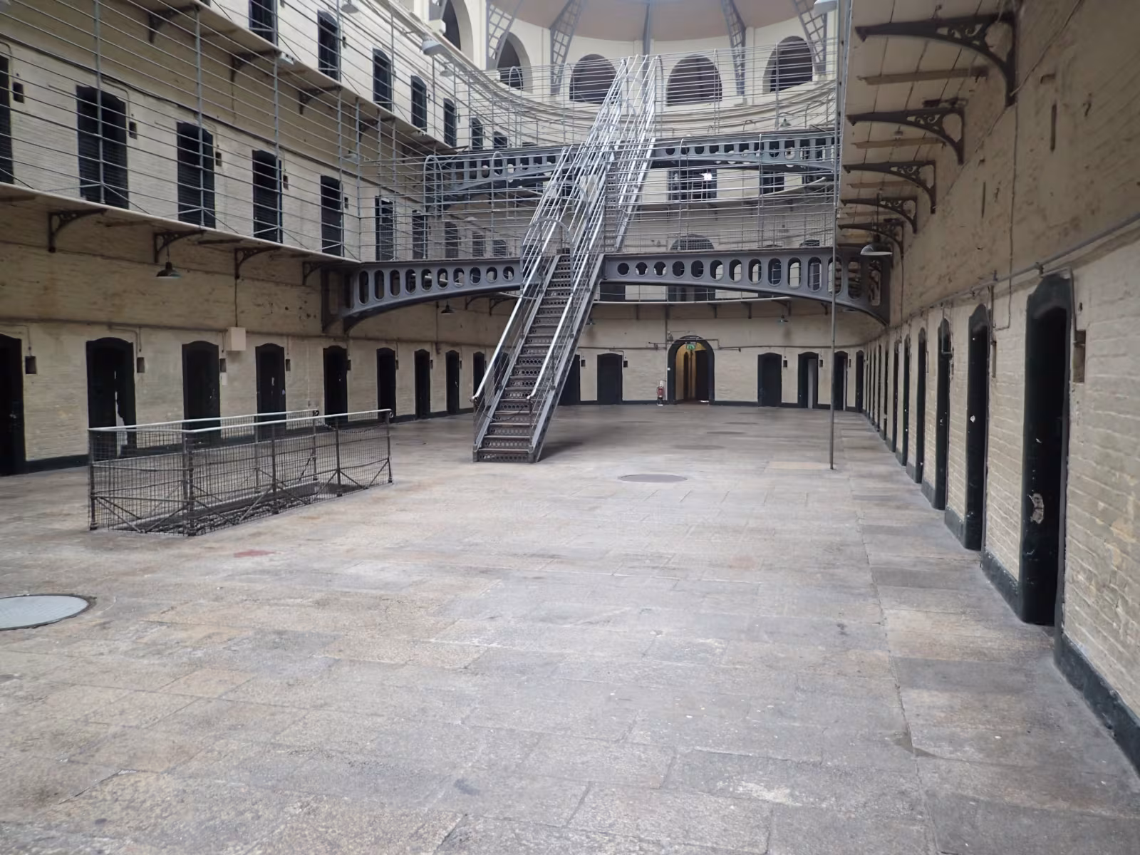 The Victorian East Wing of Kilmainham Gaol Dublin, with iron walkways, white cells and a glass roof letting in soft daylight