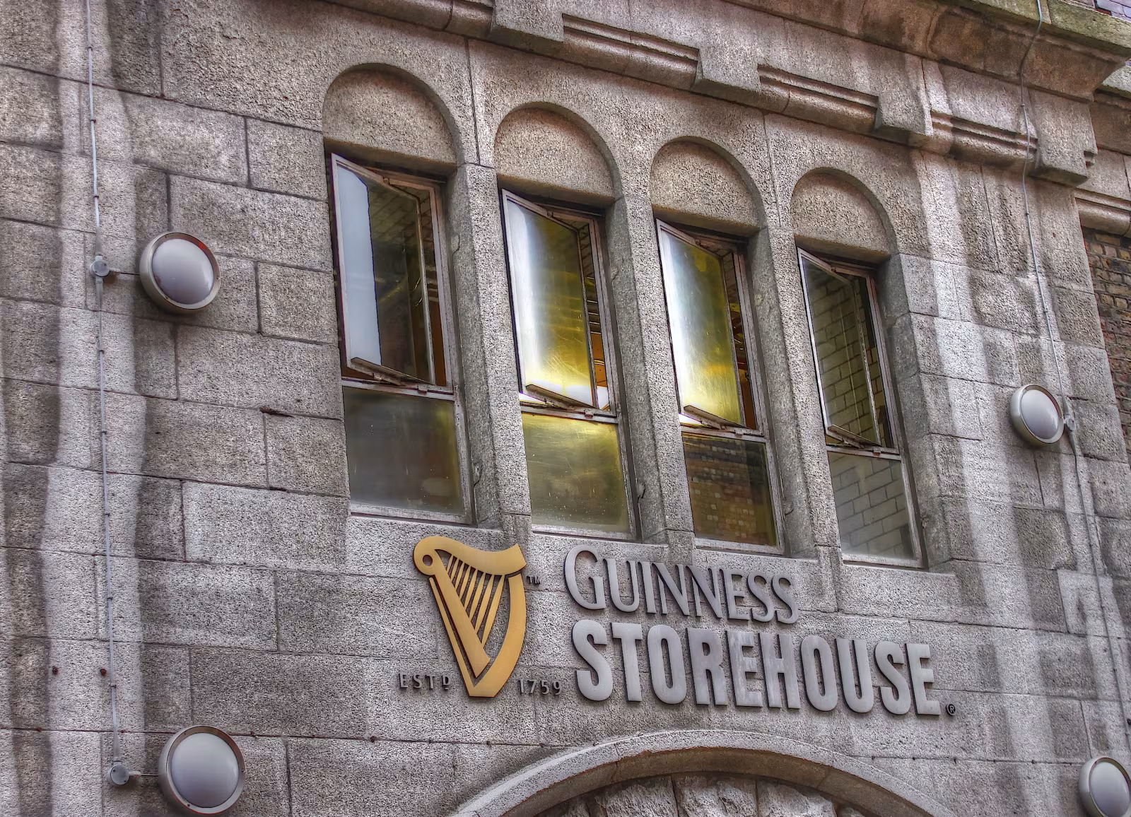 Interior brewing exhibition at the Guinness Storehouse, showing large copper fermenting vessels and process displays