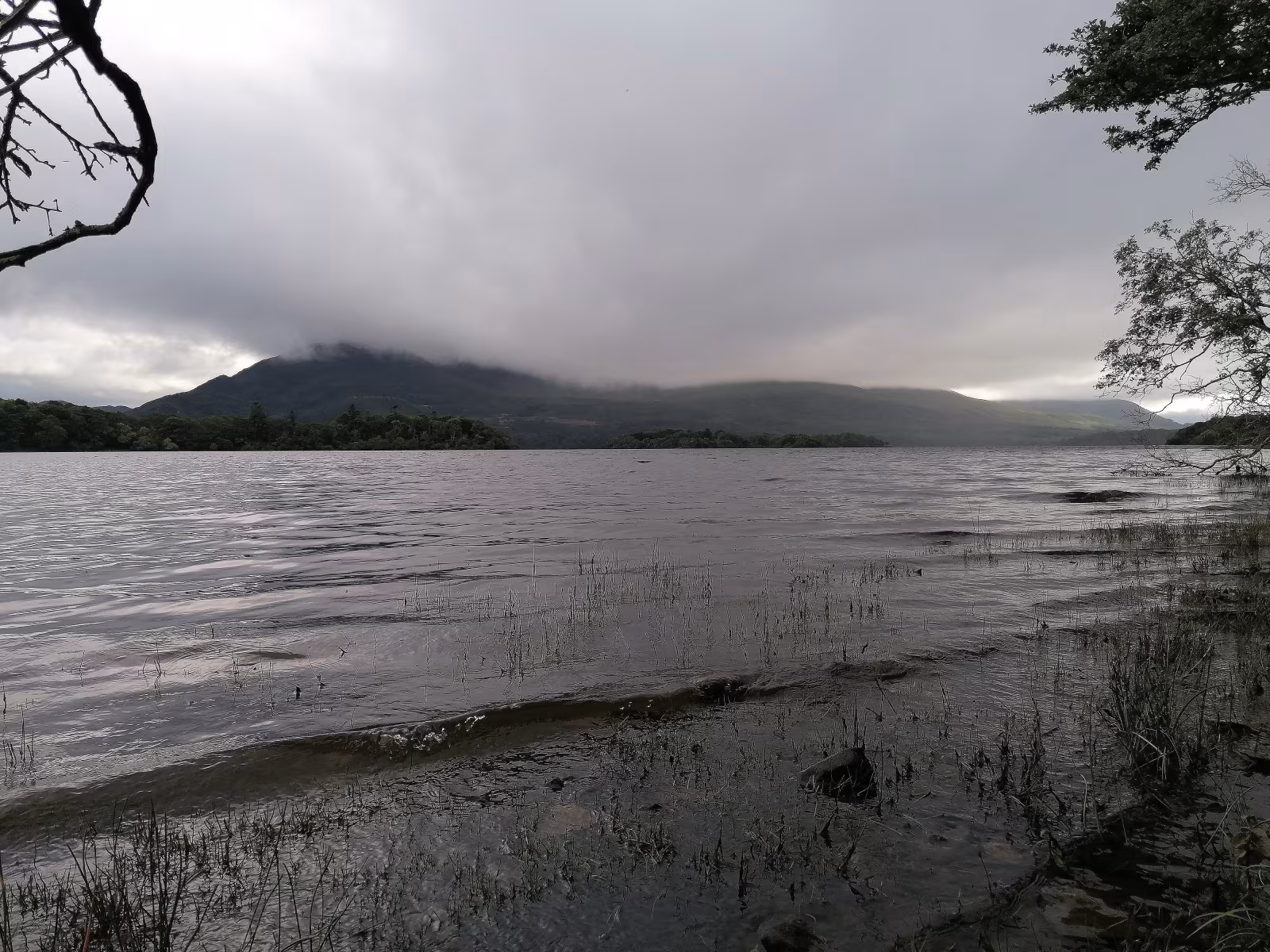 Looking southeast across Lough Leane with Tomies Mountain and Shehy Mountain rising steeply on the far shore