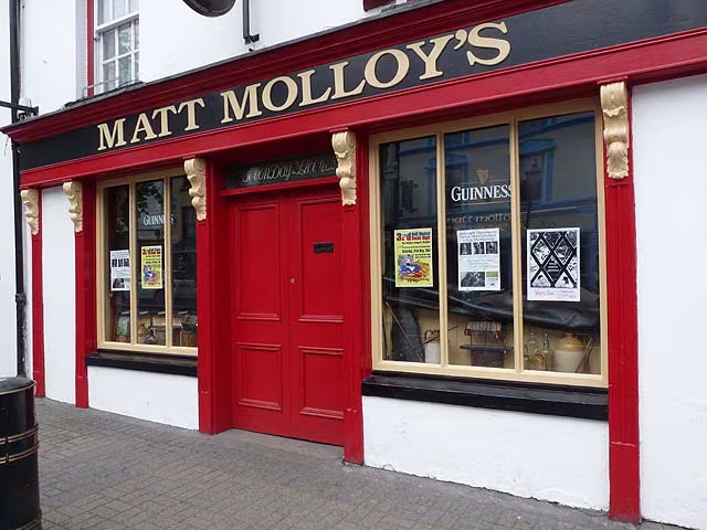 Matt Molloy's pub on Bridge Street in Westport, County Mayo, seen from the street with neighbouring buildings